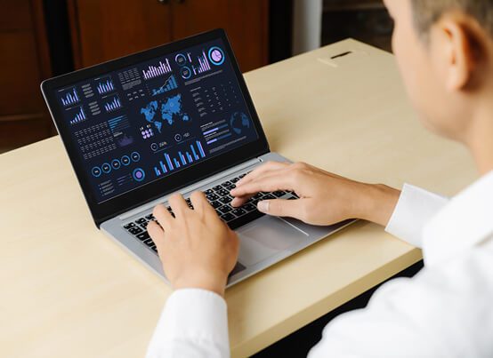 A man in a professional shirt holding a digital tablet with a shopping cart icon floating above it, representing the successful implementation of e-commerce solutions, process optimization, or digital sales management.