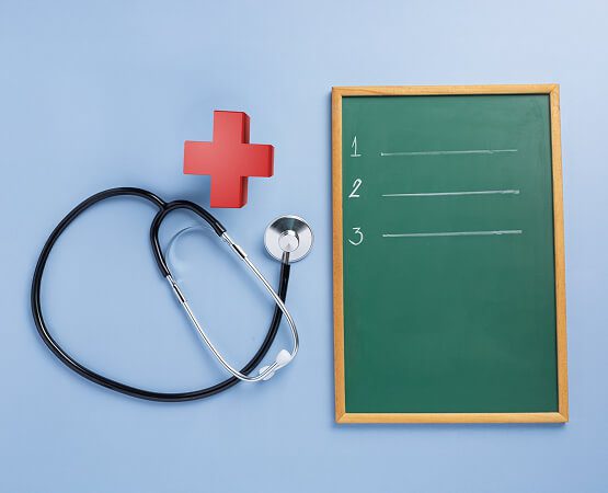 A stethoscope coiled around a red cross on a clipboard, symbolizing the key challenges of digital marketing, brand recognition, and growth in the healthcare sector.