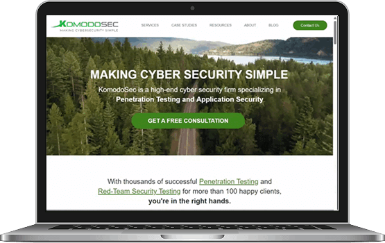 A laptop displaying the improved KomodoSec website homepage on the screen, highlighting the functional and visual success of the digital marketing project.