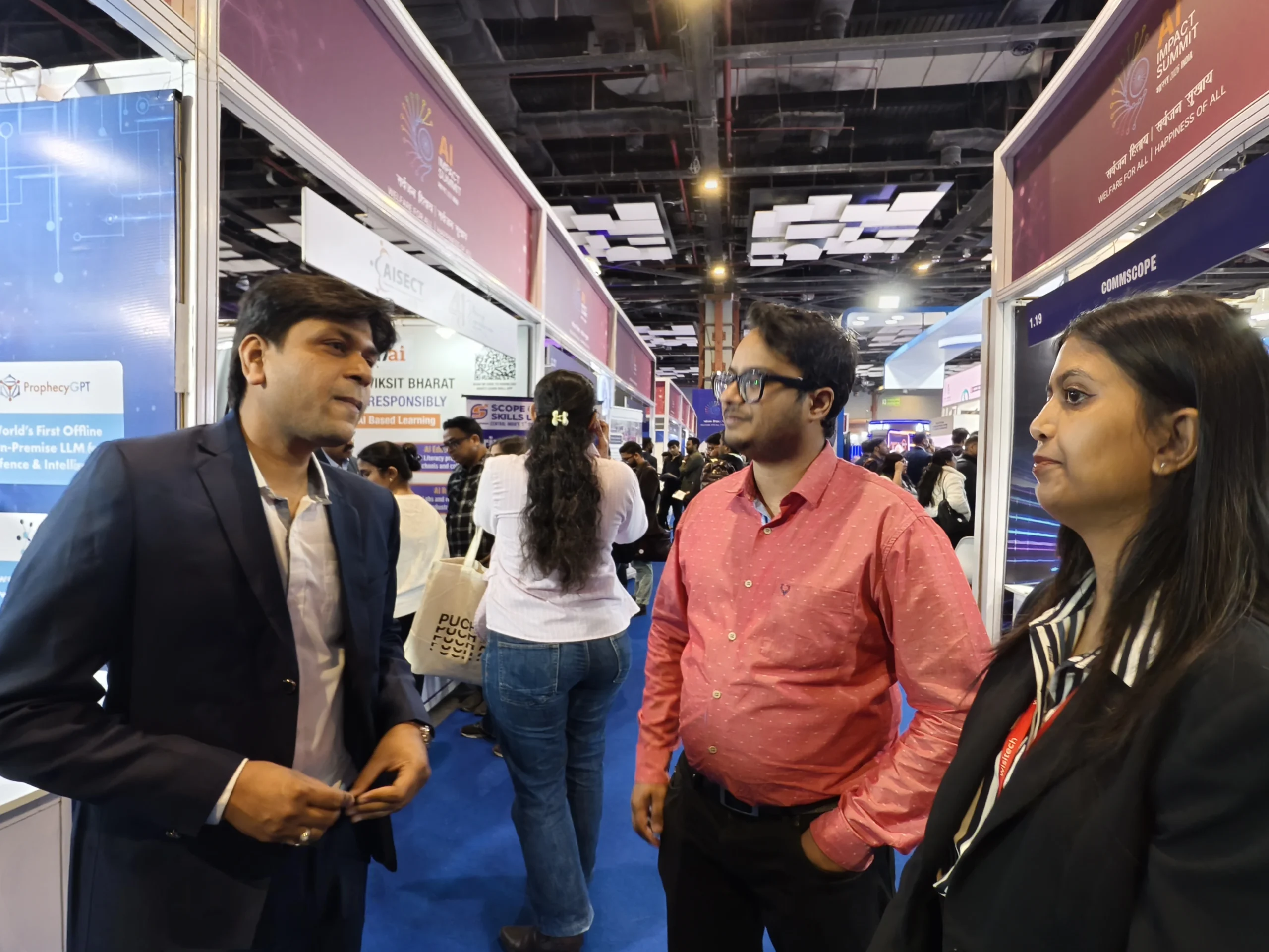 Industry discussion during AI impact summit 2026 expo floor